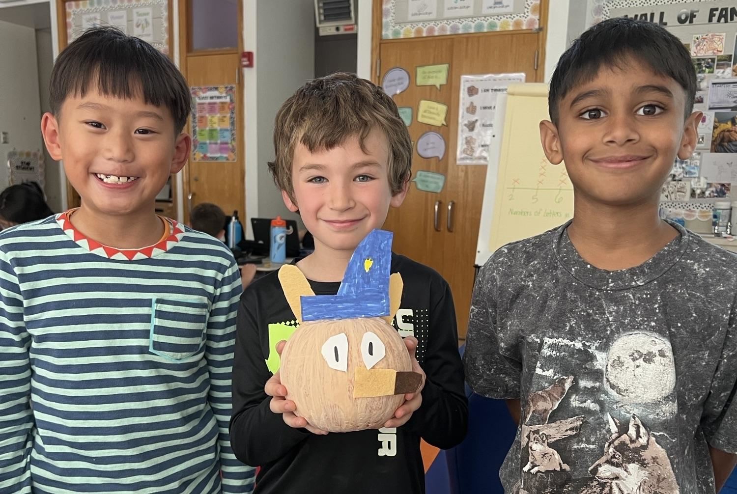  three boys with pumpkin